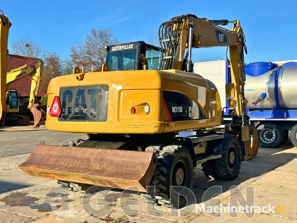Caterpillar M315D - BLADE+OUTRIGGERS